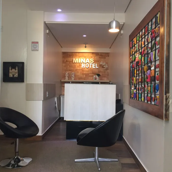 Recepção do Minas Hotel com painel de artesanato colorido na parede